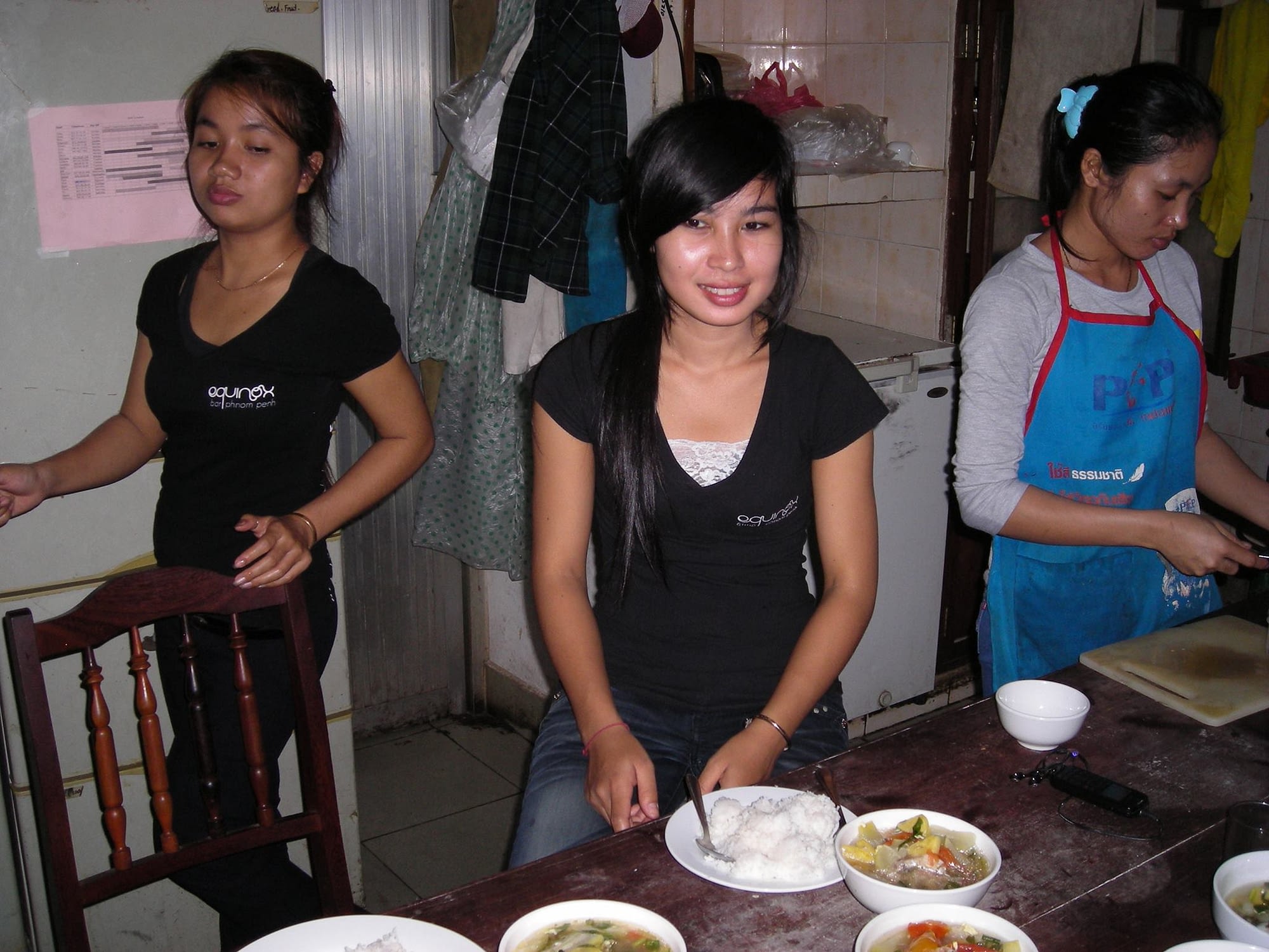 3 Cambodian women in the Equinox kitchen.