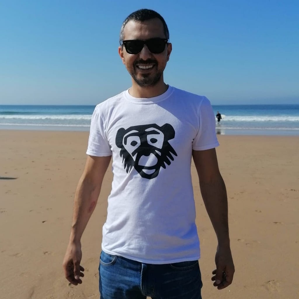 Man in a Monkey Tshirt in Portugal on the beach.