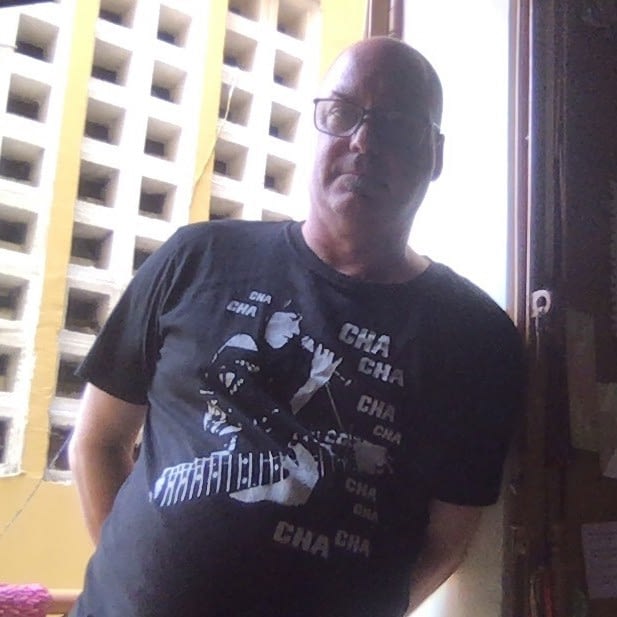 Poet and Musician, Scott Bywater wearing a t-shirt by Mrugacz in Phnom Penh.